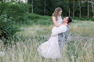 groom spins bride in a field at xxveltres wedding and event center plum pa
