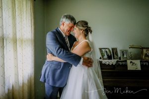 father of the bride hugging the bride