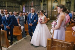bride coming down the aisle with her dad